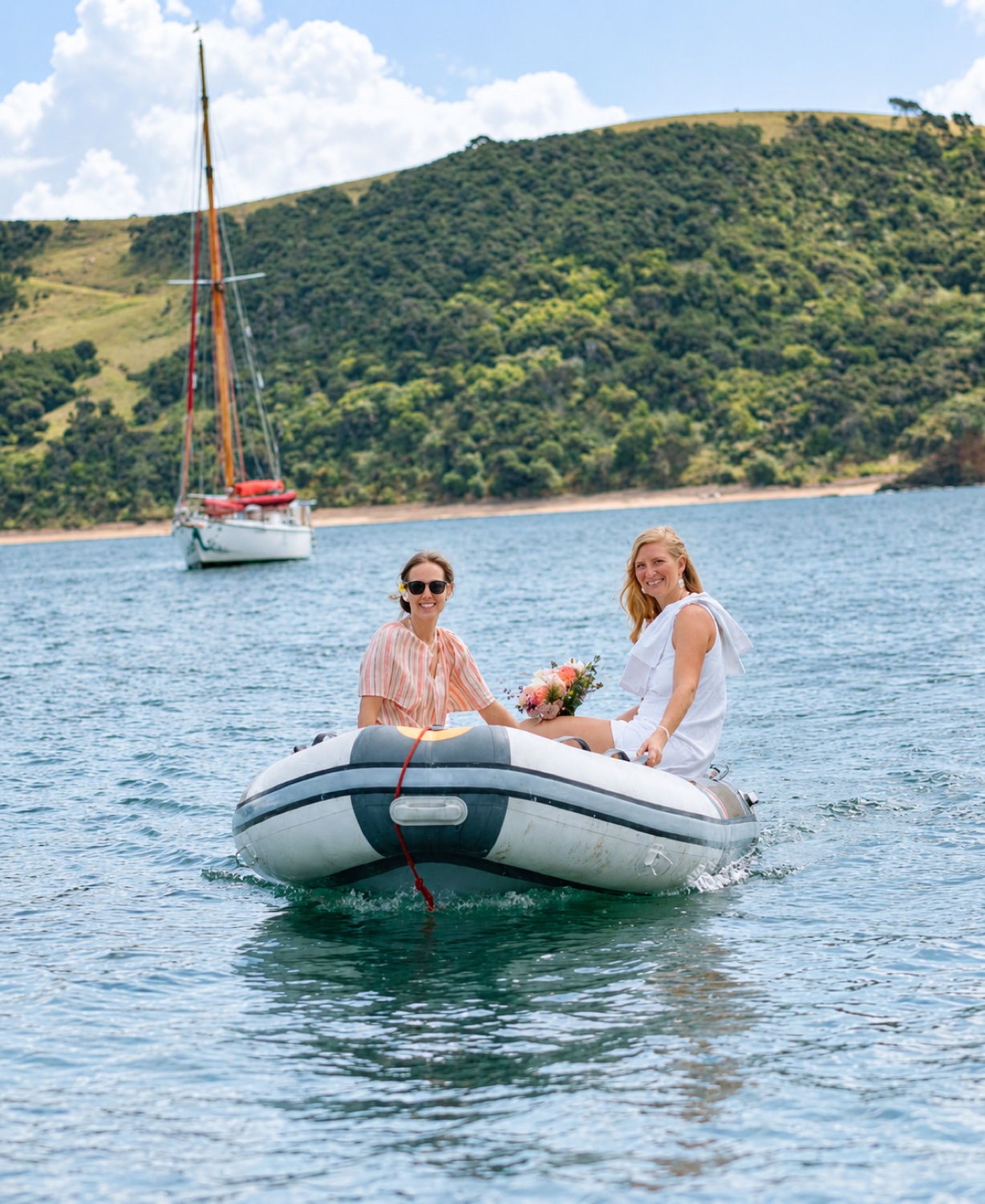 A bride arriving by inflatable boat on the water
