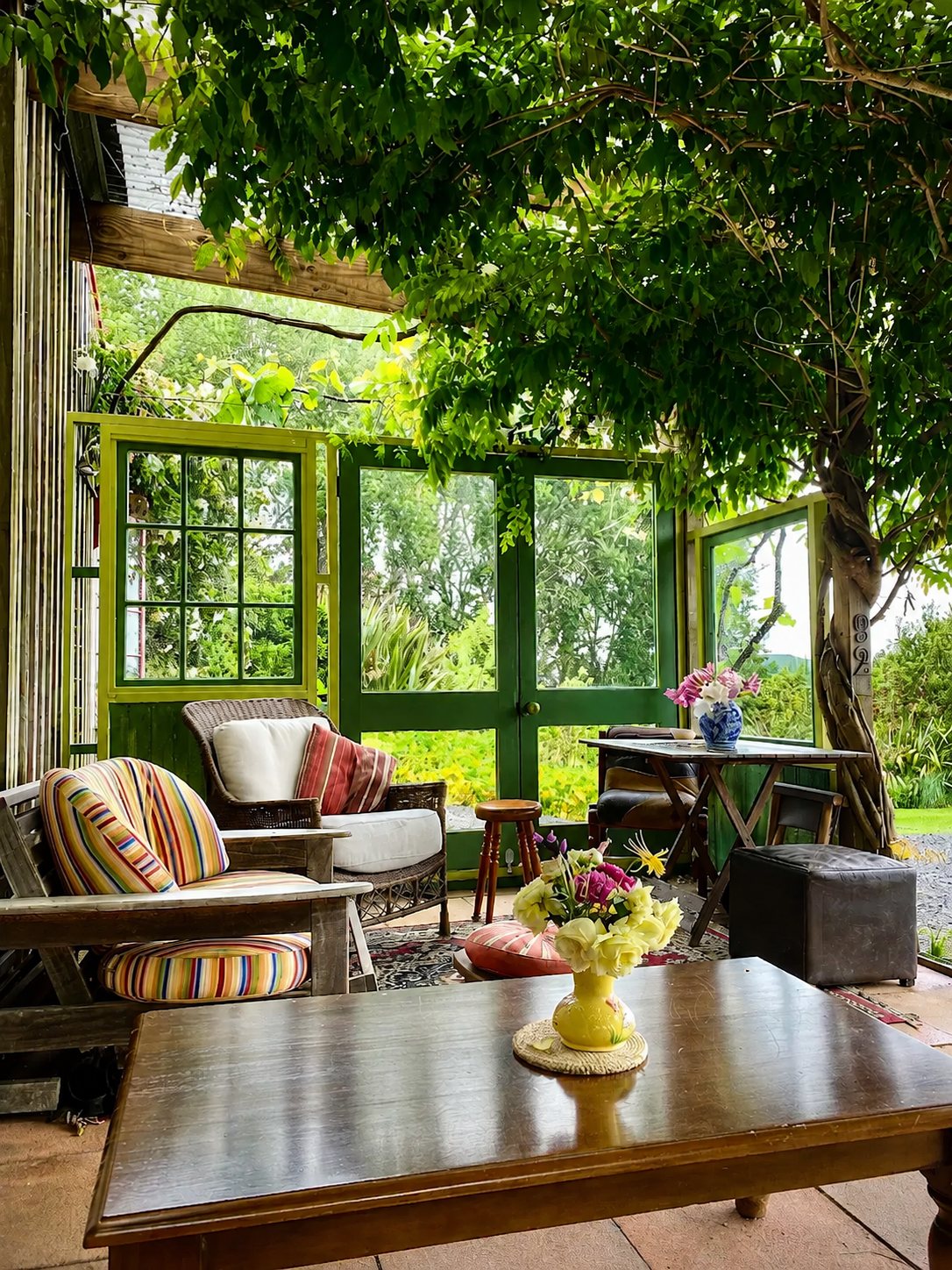 A quiet garden room set with flowers and comfortable seating for a small gathering