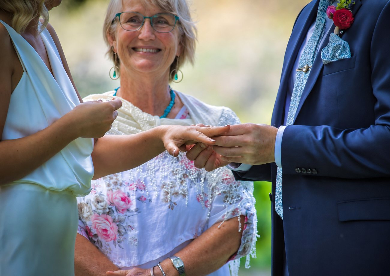 Chris binding a couple's hands together during a handfasting